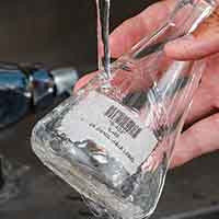 A waterproof paper label on a glass beaker.